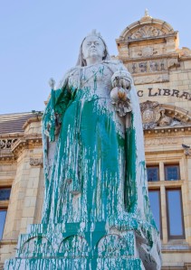In this photo taken Friday, April, 10, 2015, a statue of Britain's Queen Victoria, outside the Port Elizabeth city library in South Africa, after being splashed with green paint. Excrement thrown at the statue of British colonialist Cecil John Rhodes began a wave of vandalizing protests in South Africa. Memorials to South Africas colonial past were rejected as symbols of oppression by mainly young black protesters, as statues of British monarchs Queen Victoria and King George V were splashed with paint, in the cities of Port Elizabeth and Durban respectively.