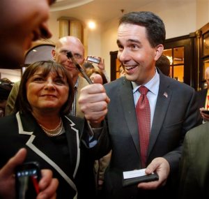 Wisconsin Gov. Scott Walker is greeted by supporters as he arrives at the Republican Leadership Summit Saturday, April 18, 2015, in Nashua, N.H. (AP Photo/Jim Cole)