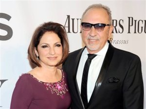 FILE - In this June 8, 2014, file photo, Gloria Estefan, left, and Emilio Estefan pose for photos at the 68th annual Tony Awards at Radio City Music Hall in New York. Gloria Estefan and her husband, Emilio, are shepherding their musical biography "On Your Feet!" to Broadway this fall, celebrating two Cuban-Americans who embraced the American Dream and now own enough Grammy Awards to fill a house. (Photo by Charles Sykes/Invision/AP, File)