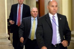 House Majority Whip Steve Scalise of La., center, leaves the offices of Speaker of the House John Boehner shortly before the House approved a stopgap spending bill to keep the federal government open, Wednesday, Sept. 30, 2015, on Capitol Hill in Washington. Just hours before a midnight deadline, a bitterly divided Congress approved the stopgap spending bill to keep the federal government open, but with no assurance there won't be yet another shutdown showdown in December.  (AP Photo/Andrew Harnik)
