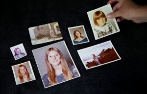 In this Thursday, June 11, 2015 photo, Lisa Long lays out family photos of her sister Karen Barnes in Jonesboro, Ga. The married couple dubbed the San Francisco witch killers seemed locked away for good when each was sentenced to 75 years to life for three murders, including Barnes' 30 years ago. Because California prisons are under court order to ease severe overcrowding, a parole board will consider whether the wife Suzan Carson, 73, is fit for release Wednesday, Dec. 2. Long has traveled to Chino, Calif., to testify against Suzans release. They are unrepentant, Long said. (AP Photo/David Goldman)