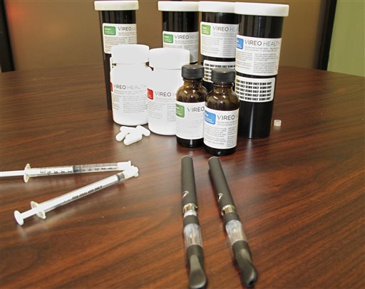 FILE - In this Jan. 5, 2016 file photo, packaging for medical marijuana is displayed at Vireo Health of New York, a dispensary in White Plains, N.Y.   When medical marijuana became legal this month in New York, one of the strictest among the 23 states to legalize the drug for medical purposes, ovarian cancer patient Brittany Barger, 27,  was one of the first patients though the dispensaries doors because her doctor was willing to take a state-required course to be able to certify her as a patient. (AP Photo/Jennifer Peltz, File)