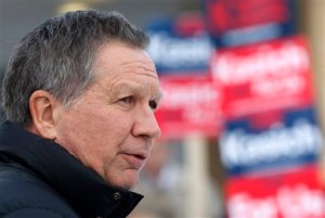 Republican presidential candidate, Ohio Gov. John Kasich visits a polling station at the high school, Tuesday, Feb. 9, 2016, in Manchester, N.H. as voters cast their ballots for the first in the nation presidential primary.  (AP Photo/Jim Cole)