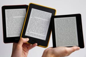 Amazon's Kindle Oasis, far right, the company's sleekest, lightest e-reader, which sells for $290, is shown in comparison with two earlier Kindle models, the Voyage, left, at $200, and the Paperwhite, on sale for $100, center, Thursday, April 28, 2016, in New York. The Oasis, meant to be a luxury e-book reader, is designed strictly for reading, without Facebook, streaming video and other distractions common on full-functioning tablets. (AP Photo/Kathy Willens)