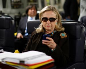 FILE - In this Oct. 18, 2011, file photo, then-Secretary of State Hillary Rodham Clinton checks her Blackberry from a desk inside a C-17 military plane upon her departure from Malta, in the Mediterranean Sea, bound for Tripoli, Libya.Clinton is telling voters not to trust Donald Trump, but a new government report about her usage of a private server as secretary of state is complicating that message. The sharp rebuke from the State Departments Inspector General, which found Clinton did not seek legal approval for her homebrew email server, guarantees that the issue will remain alive and well for the likely Democratic presidential nominee. (AP Photo/Kevin Lamarque, Pool, File)