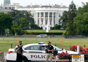 Law enforcement personnel stand near the Ellipse south of the White House on Constitution Avenue, Friday, May 20, 2016 in Washington. A uniformed Secret Service officer shot a person who drew a weapon just outside the White House Friday afternoon, a U.S. law enforcement official said. (AP Photo/Alex Brandon)