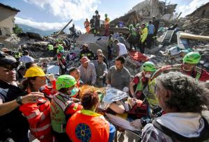 FILE - In this Wednesday, Aug. 24, 2016 file photo, rescuers carry an injured woman on a stretcher after a strong earthquake earlier in the morning in Amatrice, central Italy. Experts say the vast majority of rescues occur in the first 24 hours after a disaster - after that, the chances of survival drop as each day passes. (Massimo Percossi/ANSA via AP)