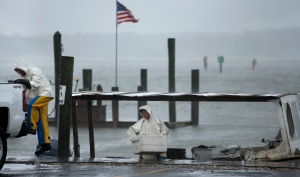 Charlie Gregory, center, a local crabber, and his son Zach check their boat as Tropical Storm Hermine approaches Virginia Beach, Va., Saturday, Sept. 3, 2016. The National Hurricane Center says Tropical Storm Hermine could bring 4 to 7 inches of rain to southeastern Virginia and the Atlantic coastal portion of Maryland as well as 1 to 4 inches of rain over southern Delaware, southern and eastern New Jersey and Long Island through Monday morning. (Stephen M. Katz/The Virginian-Pilot via AP)