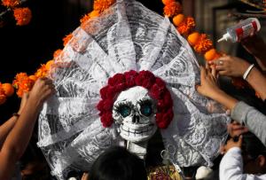 In this Thursday, Oct. 27, 2016 photo, residents work on a skeleton representation as part of the Day of the Dead festivities in Mexico City. The capital city will hold its first Day of the Dead parade Saturday, complete with floats, giant skeleton marionettes and over 1,000 actors, dancers and acrobats in costumes. (AP Photo/Marco Ugarte)