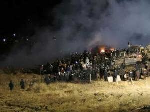 In this image provided by Morton County Sheriff’s Department, law enforcement and protesters clash near the site of the Dakota Access pipeline on Sunday, Nov. 20, 2016, in Cannon Ball, N.D. At least one person arrested as protesters sought to push past a bridge on a state highway that had been blockaded since late October. (Morton County Sheriff’s Department via AP)
