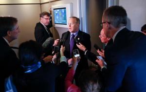 White House press secretary Sean Spicer speaks to reporters on Air Force One en route to Andrews Air Force Base, Thursday, Jan. 26, 2017, from Philadelphia. Spicer says that taxing imports from Mexico would generate $10 billions a year and "easily pay for the wall." (AP Photo/Pablo Martinez Monsivais)