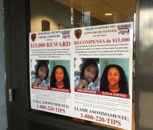 FILE - In this Oct. 24, 2016 file photo, a poster displayed at a Suffolk County police precinct in Bay Shore, N.Y., offers a $15,000 reward for information leading to the arrest of the person(s) responsible for the slayings of Nisa Mickens and her lifelong friend Kayla Cuevas. Federal agents said Thursday March 2, 2017, that they have caught the members of a violent El Salvadoran street gang who killed three teenagers last year, including the two girls who were inseparable best friends at their Long Island high school. (AP Photo/Michael Balsamo, File)
